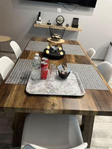a wooden table with drinks and a bowl on it at Diamond Spa in Sallaumines +5 photos