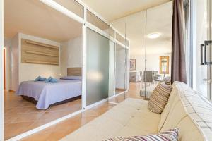 a bedroom with a bed and a living room at Lovely apartment in Callao Salvaje in Callao Salvaje +17 photos