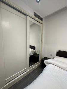 a bedroom with a large glass window with a bed at central apartment for rent 19 in Umm Uthainah