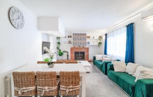 a living room with a table and chairs and a fireplace at 2 Bedroom Lovely Home In Carratraca in Carratraca