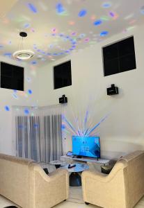 a living room with two couches and a room with blue lights at 803 Villa AFamosa Villa in Kampong Ulu Pegoh