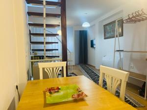 a dining room with a wooden table and chairs at Charming House in Pogradec