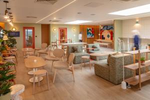 a restaurant with tables and chairs in a room at SeaSpace in Newquay