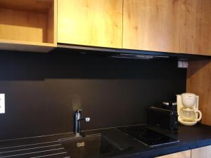 a kitchen counter with a sink and a microwave at Studio confortable pour 4 personnes à Arc 1600, proche des pistes - FR-1-411-396 in Arc 1600