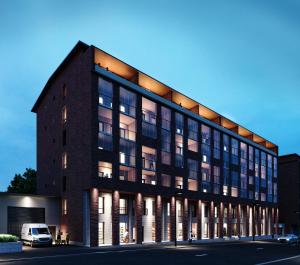 a building with a van parked in front of it at Aurora suites with AIR CONDITIONING in Rovaniemi