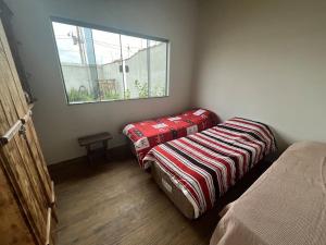 a small room with a bed and a window at Casa aconchegante-lazer completo in Três Pontas +17 photos