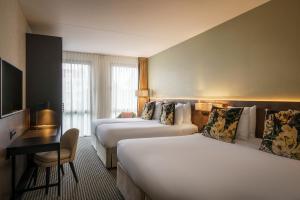 Letto o letti in una camera di Monet Garden Hotel Amsterdam