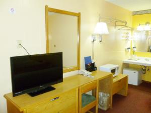 une chambre d'hôtel avec une télévision sur un bureau dans l'établissement Royal Rest Motel, à Chariton