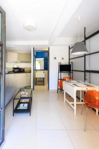 a kitchen and living room with a table and chairs at AIOLOS glyfada centre apartment 3 in Athens