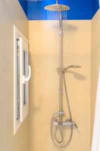 a shower with a shower head in a bathroom at AIOLOS glyfada centre apartment 3 in Athens