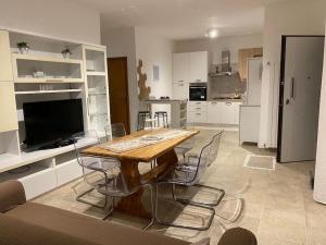a kitchen with a wooden table and chairs in it at Casa LorEnzo in Manziana