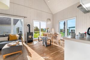 a living room with a couch and a table at Ferienhaus Olpi Olpenitz in Olpenitz