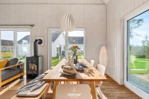 a dining room with a wooden table and chairs at Ferienhaus Olpi Olpenitz in Olpenitz +35 photos