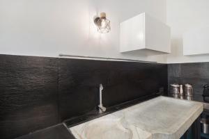 a kitchen with a sink and a faucet at Da Linda in Cisano sul Neva