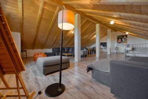 a living room with a floor lamp and a couch at Villa & SPA My Koltrina in Svetvinčenat +99 photos