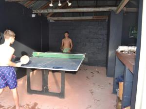 two men standing in a room with a ping pong table at Journey Guesthouse in Riversdale +18 photos