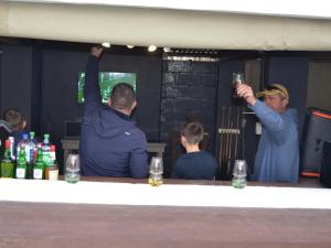 a group of people sitting around a bar drinking at Journey Guesthouse in Riversdale +16 photos