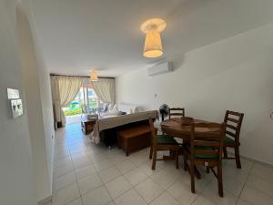 a living room with a table and a couch at Beautiful 1-bd Ap near the beach historic places in Paphos