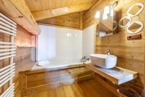 a bathroom with a white sink and a tub at Chalet Le Moulin des Neiges - Solliet in Montvalezan +26 photos
