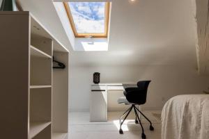 Un dormitorio con un escritorio y una silla en una habitación. en Le Loft Caché, en Carcassonne