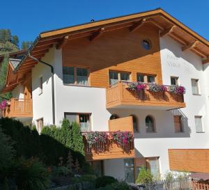 a building with balconies and flowers on it at Haus Viola in Samnaun