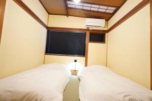 Letto o letti in una camera di 宿屋GONDO aioi
