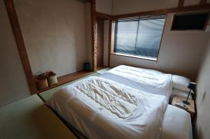 Letto o letti in una camera di 宿屋GONDO aioi