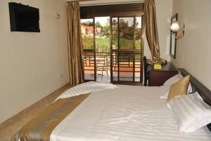 Postel nebo postele na pokoji v ubytování Tristar Hotel Kampala
