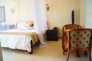 Postel nebo postele na pokoji v ubytování Tristar Hotel Kampala