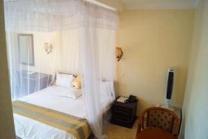 Postel nebo postele na pokoji v ubytování Tristar Hotel Kampala