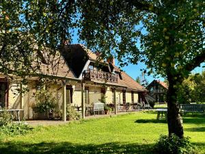 a house with a deck on the side of it at Karlamuiza Country Hotel in Kārļi