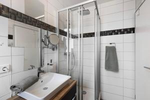 a bathroom with a sink and a shower at Fewo Seeschwalbe - Marina Mücheln in Mücheln +11 photos