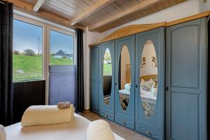 a bedroom with a large blue cabinet with mirrors at Fewo Seeschwalbe - Marina Mücheln in Mücheln