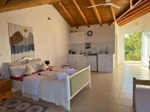 a bedroom with a large bed and a kitchen at FILOXENIA Studio 7 in Kómboi