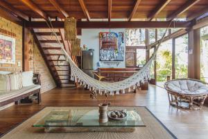 a room with a hammock in a house at A Casinha da Floresta in Gamboa