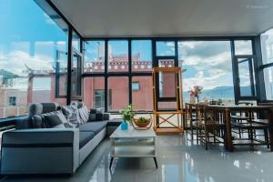 a living room with a couch and large windows at 云硕客栈 in Shangri-La