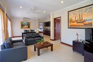 a living room with a couch and a table at Kuta Town House Apartments in Kuta