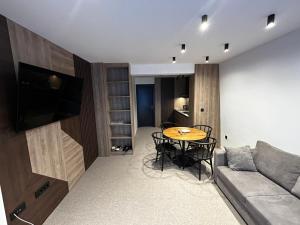 a living room with a couch and a table at La Familia in Jahorina