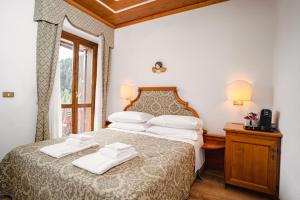 Postel nebo postele na pokoji v ubytování Hotel Sporting