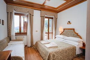 Postel nebo postele na pokoji v ubytování Hotel Sporting