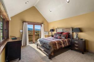 a bedroom with a bed and a large window at Cowboy Lake Lodge in Emigrant