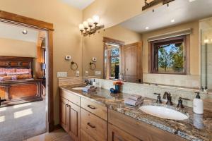 a bathroom with a sink and a large mirror at Cowboy Lake Lodge in Emigrant +36 photos