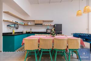 a kitchen with a table with a christmas tree on it at Kim Villa 45 - Cách Bãi Tắm 100 Met - Full Máy Lạnh Các Phòng - Bida - Phòng Karaoke - Siêu Gần Biển in Vung Tau