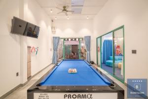 a large blue ping pong table in a room at Kim Villa 45 - Cách Bãi Tắm 100 Met - Full Máy Lạnh Các Phòng - Bida - Phòng Karaoke - Siêu Gần Biển in Vung Tau +27 photos
