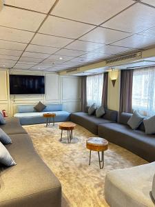 a living room with couches and tables in a room at Luxor Aswan Coral 2 Nile Cruise every Saturday from Luxor 4 nights & every Wednesday from Aswan 3 nights in Luxor