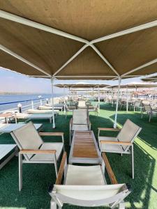 a row of chaise lounge chairs on the beach at Luxor Aswan Coral 2 Nile Cruise every Saturday from Luxor 4 nights & every Wednesday from Aswan 3 nights in Luxor