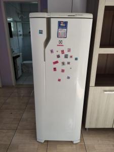 a refrigerator with magnets on it in a kitchen at Casa mobiliada privativa in Caiçara
