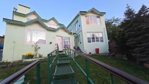 a house with stairs leading to the front of it at Departamentos aćawaia in Ushuaia