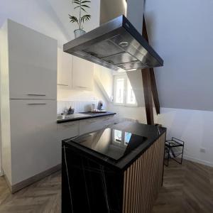 a kitchen with a stove top oven in a room at Duplex design - 6 personnes - Charleville-Mézières in Charleville-Mézières +10 photos