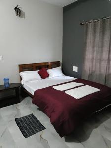 a bedroom with two beds with towels on them at Coorg wildstone Homestay in Madikeri